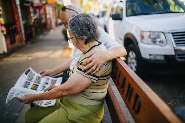 Two people sitting on a bench reading a newspaper